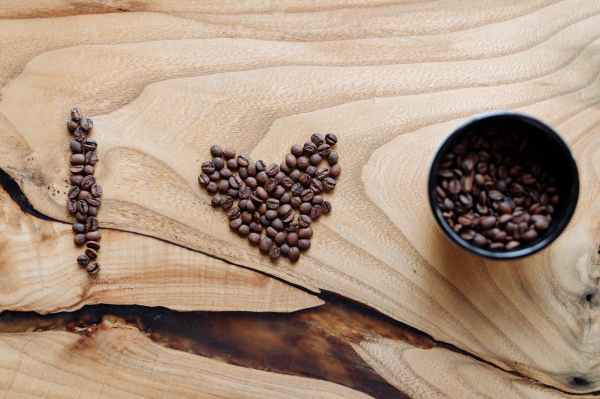 roasted coffee beans on a wooden surface