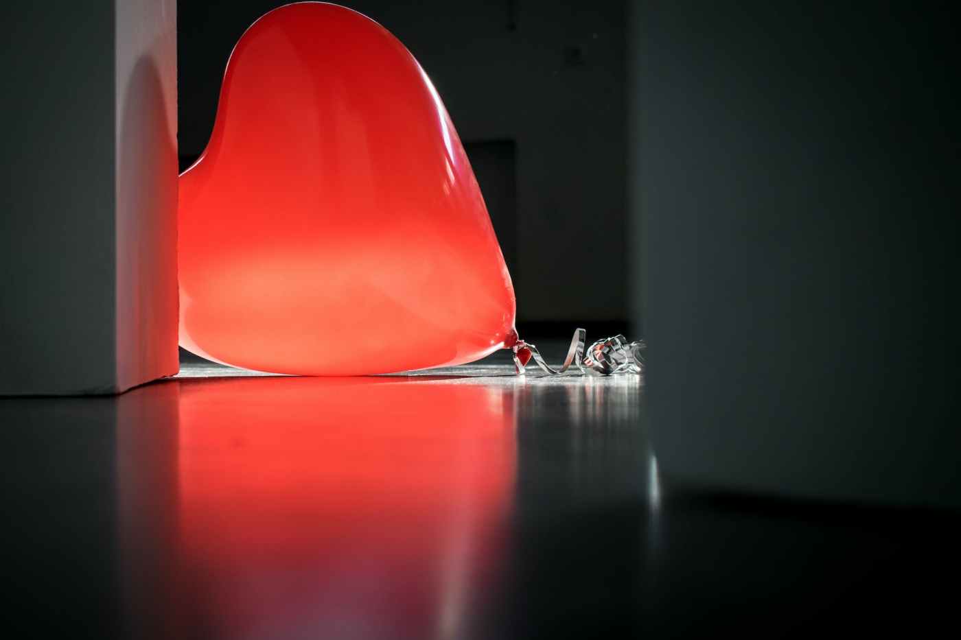 red heart balloon on top of floor